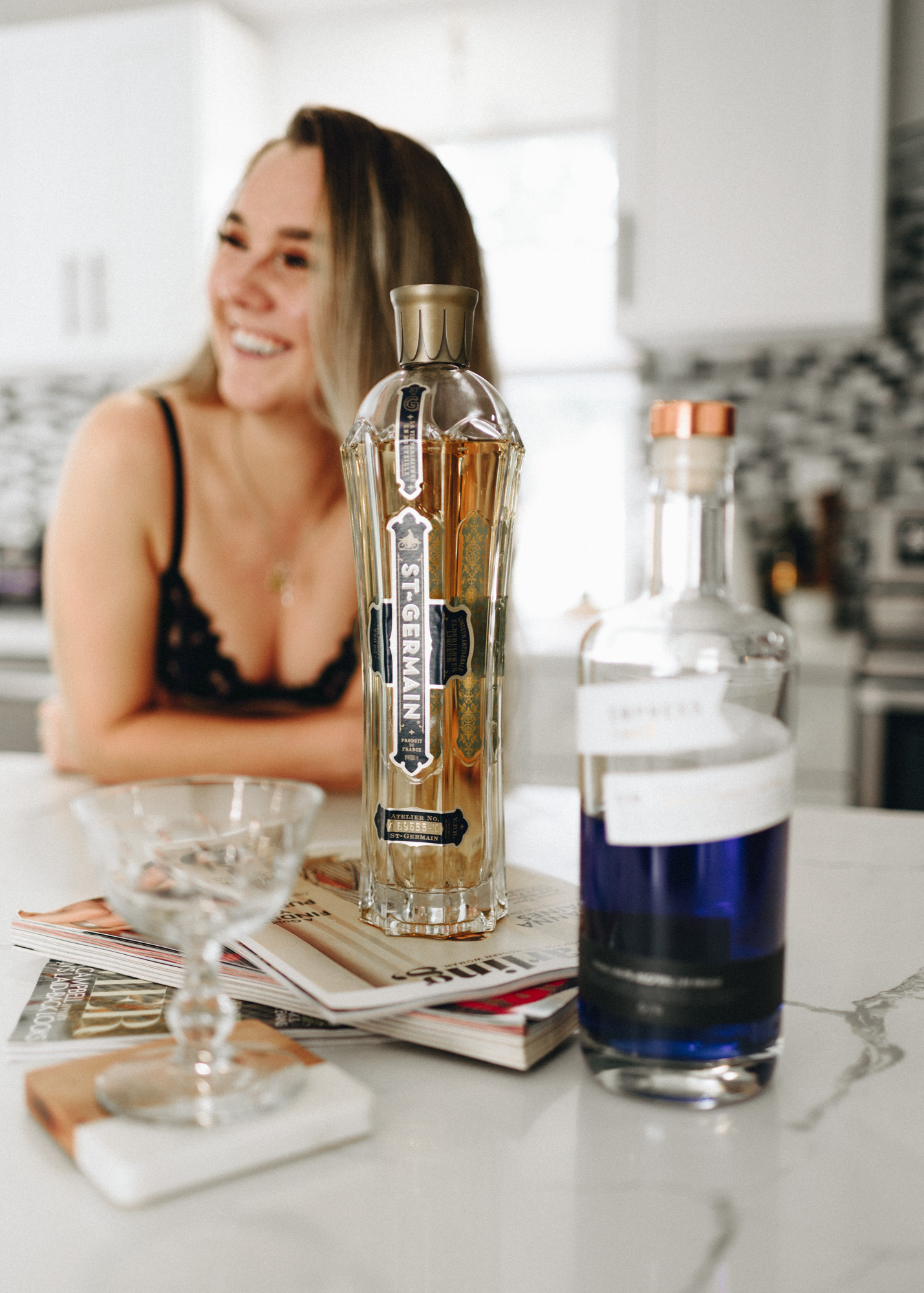 Clair in the kitchen with St. Germain and Empress Gin